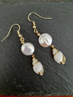 These beautiful earrings are made from real gold plated seashells and Baroque Pearls. The seashells are around 18mm long, Baroque Pearl  12mm, ear-wires are gold filled. Each item is carefully packaged in a beautiful jewellery box ready as a gift. If you would like to add a personalized note with your order, just write a note at checkout and I will send a small card with your gift to the recipient. If you need a bigger quantity or any customized jewellery for your very special occasion (birthdays, weddings, bridal showers or any other event), please send me a message and I'll be glad to help. Shell Drop Earrings With Matching Set, Shell Drop Earrings Jewelry Set, Gold Teardrop Earrings For The Beach, Elegant Nickel-free Shell Jewelry, Elegant Gold Shell-shaped Jewelry, Gold Pearl Drop Earrings In Mother Of Pearl, Yellow Gold Pearl Drop Earrings With Mother Of Pearl, Yellow Gold Pearl Drop Earrings In Mother Of Pearl, Shell-shaped Pearl Charm Earrings As Gift