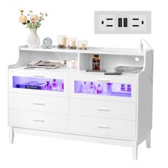 a white cabinet with drawers and lights on it