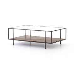 a coffee table with glass top and metal frame, on a white background in front of a wall