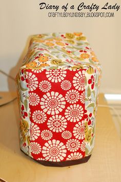 a red and white box sitting on top of a wooden table