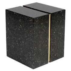 two black marble cubes sitting side by side on top of each other with gold trim