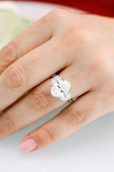 a woman's hand with a diamond ring on it