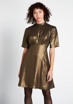 Make a grand entrance at the next soiree in this dark gold A-line dress. Easy to wear with boots or heels, this shimmery, short sleeve piece by Emily and Fin was made for fashionistas—just like you ! Shell: 100% Polyester. Lining: 100% Viscose. Machine wash. Side pockets. Fully lined. Back zipper with button closure. Imported Model is wearing size:S Fabric does not provide stretch. S=36 inches Length XXL=38.5 inches Length | Emily and Fin Shake and Shimmer A-Line Dress in Gold, Size 2XS Gold A Line Dress, Vintage Style Swimwear, Casual Dresses Plus Size, Midi Dress Plus Size, Vintage Swimwear, Midi Dress Casual, Grand Entrance, Dark Gold, Fit N Flare Dress