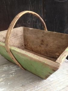 a wooden basket sitting on top of a table