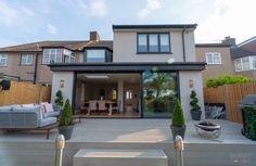 an outdoor living area with patio furniture and landscaping