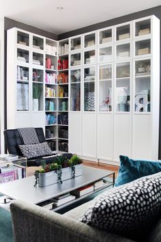 a living room filled with furniture and bookshelves