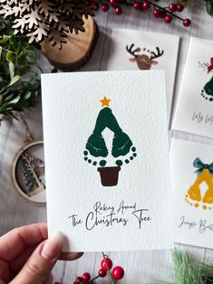 four christmas cards with trees and bells on them