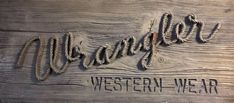 the western new sign is carved into wood