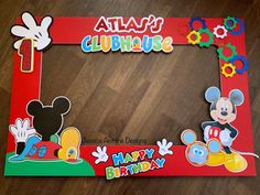 a mickey mouse photo frame is shown on a wooden floor with the words, happy birthday