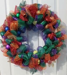 a colorful wreath hanging on the front door