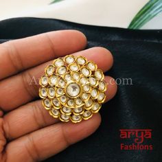 Tyaani Inspired Pacchi Kundan Golden Adjustable Ring Features: Adjustable Ring to match any finger size 22 Karat Gold Finish Lightweight Jewelry Made in Brass with very high quality Kundan stones Suitable for any occasion and traditional or Modern attire Ready to ship and available for local pickup from 23059. Please message us for more details Free shipping on orders above $75 within USA. Round Tilla Rings For Wedding, Handmade Temple Jewelry Style Round Ring, Traditional Adjustable Rings For Festive Occasions, Handmade Traditional Flower Ring For Anniversary, Traditional Handmade Flower Ring For Anniversary, Kundan Toe Ring As Gift, Stone Work Toe Ring Jewelry As Gift, Temple Jewelry Style Rings With Stone Setting For Festivals, Hand Set Rings For Festivals And Gifts