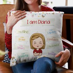 a woman sitting in a chair holding a pillow with the words i am diama on it