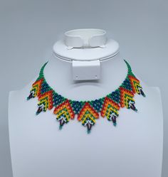 This beautiful beaded necklace is hand-woven by the women of the Embera Chami Indigenous Tribe of Colombia Handmade Multicolor Southwestern Beaded Necklaces, Hand-strung Beaded Necklaces For Festivals, Handmade Southwestern Multicolor Beaded Necklaces, Traditional Adjustable Handwoven Necklaces, Traditional Handwoven Adjustable Necklace, Artisan Beaded Adjustable Bib Necklace, Artisan Beaded Bib Necklace With Adjustable Fit, Multicolor Southwestern Style Necklaces, Handwoven Beaded Necklace For Festival