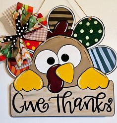 a wooden sign that says, one thanks with a turkey on it's head