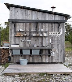 an old outhouse with pots and pans on the outside