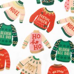 christmas sweaters and hats cut outs on a white surface