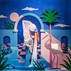 an image of a stage set with flamingos and storks