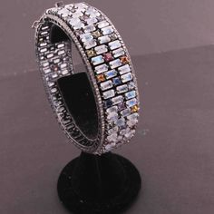 One (1) Pc Pave Diamond Excellent Designer Rainbow Moonstone & Multi Sapphire Bangle Bracelet - 925 Sterling Silver -Bangle With Lock BD077 Approx Measurement: Size: 2.4+inches Diameters (inside) Diamond Wt: 3.25 cts Silver Purity: 925 Metal: Sterling Silver Finish : Oxidized Gemstone : Rainbow moonstone , Multi Sapphire Sold As: 1 Pc We are continuously adding new products in our store. So keep coming back to see more great deals on gems in our mart. Amazing quality at the best price around White Moonstone Bangle, Fine Jewelry White Gold Gemstone Bangle, White Gold Gemstone Bangle Fine Jewelry, White Gold Gemstone Bangle, White Multi-stone Bracelet, White Gold Multi-stone Round Bracelet, White Bangle With 17 Jewels, Cubic Zirconia Multi-stone Bangle, Multi-stone Cubic Zirconia Bangle