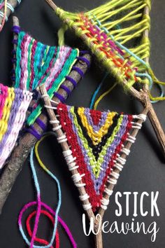 several different colors of yarn hanging from clothes pins with text overlay that says stick weaving