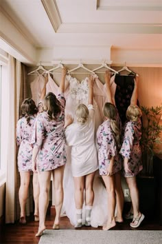 the bridesmaids are trying to hang their wedding dresses