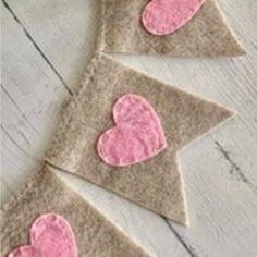 three pieces of felt with pink hearts on them