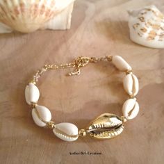 A bracelet that smells of the ocean with its small, natural, off-white cowrie shells and its golden shell. Adjustable length: 5 to 6 inch Large chain links Golden stainless steel   The story...  In Africa, the cowrie shell is considered as a lucky charm. Those who wore them were assured of powerful protection from the ocean spirits. The cowrie shell was also supposed to bring prosperity to its owner. ☀️☀️All the jewellery and accessories on https://www.etsy.com/fr/shop/AtelierBelCreation  💡 Care instructions:  Avoid contact with water, cleaning products and perfume as much as possible, as these may remove the shine from the jewellery. In order to clean them, simply use a dry cloth which will restore the shine to the material.  Follow me on Instagram @atelierbelcreation