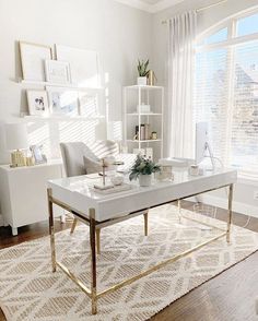 the living room is decorated in white and gold with lots of decor on top of it