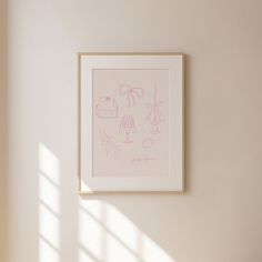 a white framed artwork hanging on the wall