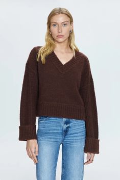 COLOR: Dark Roast Textured, medium-weight pullover sweater. Designed for boxy, relaxed silhouette with oversized cuffed sleeves, cropped length hem, and wide V open neckline. Oversized ribbing details at neckline, cuffs, and hem. Offered in a dark brown hue. SWIRL STYLIST NOTE* Pair this cozy sweater with our Lexi Jean and Caty boot for an effortless seasonal look. DETAILS + CARE: 64% Acrylic / 13% Polyester / 9% Nylon / 8% Alpaca / 4% Wool / 2% Spandex Hand wash on cold Lay flat to dry Length : Best Swimwear, Boxy Sweater, Knit Bottom, Textured Sweater, Football Tees, Dark Roast, Romper Pants, Cozy Sweaters, Cuff Sleeves