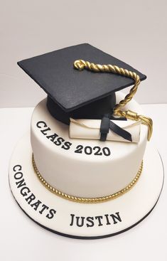 a graduation cake with a mortar and tassel on top