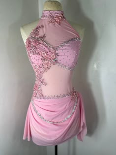 a mannequin dressed in pink with beading on it's neckline