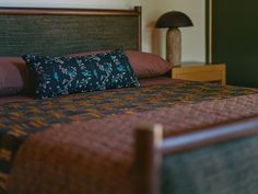 a bedroom with a bed, night stand and lamp