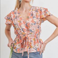 This Colorful Floral Top Has A Very Lovely Tiered Flutter Short Sleeves. It Features A Wrap Style Neckline And Tie Details Around The Waist. It Surely Makes Very Beautiful Outfit And Vacation Ready. *True To Size* Cinched Elastic Waistband Unlined Fabric: 100% Polyester Care: Machine Wash Cold On Gently, Lay Flat To Dry X-Small: Bust: 30-34" // Length: 20" Small: Bust: 32-36" // Length: 21" Medium: Bust: 34-38" // Length: 22" Large: Bust: 36-40" // Length: 23" ** Length Measurements Are Taken Fr Spring V-neck Top With Elastic Waistband, Spring Floral Print Blouse With Butterfly Sleeves, Spring Tops With Smocked Back And Flutter Sleeve, Flutter Sleeve Tops With Smocked Back For Spring, Spring Tops With Elastic Waistband, Fitted Tops With Elastic Waistband For Spring, Feminine Floral Print Top With Butterfly Sleeves, Floral Print Butterfly Sleeve Blouse For Brunch, Feminine Floral Print Tops With Butterfly Sleeves