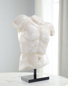 a white sculpture sitting on top of a table