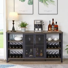 a wine rack with bottles and glasses in front of two framed pictures on the wall