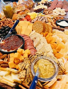 a table full of different types of cheeses and meats