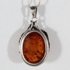 -Vintage Sterling Silver Leaf and Grape Natural Honey Amber Necklace -Chain length: 17.5 in -Pendant size: 1.75 in x 1.25 in x 0.5 in -Total weight: 21.8 g -Marked 925 Classic Amber Pendant Necklace, Vintage Amber Jewelry With Engraved Details, Vintage Amber Engraved Jewelry, Vintage Oval Necklace With Polished Finish, Antique Amber Pendant Necklace, Antique Amber Pendant Necklaces, Vintage Oval Necklaces With Polished Finish, Vintage Wedding Necklaces With Polished Finish, Vintage Wedding Necklace With Polished Finish