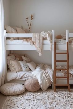 there are two bunk beds with pillows on the bottom and one is made from wood