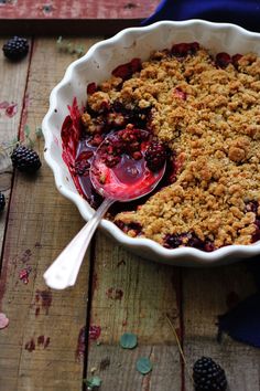 a berry crisp in a bowl with a spoon