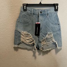 Mid Blue Wash Ripped Denim Shorts, Size 2, New With Tags Trendy Light Wash Distressed Bottoms, Ripped Short Length Jeans, Spring Ripped Medium Wash Jean Shorts, Ripped Medium Wash Jean Shorts For Spring, Distressed High Rise Bottoms For Day Out, Trendy Distressed Short Bottoms, Ripped Shorts For Spring, Spring Distressed Denim Blue Shorts, Ripped Medium Wash Shorts For Day Out