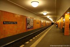 a subway station with people waiting for the train