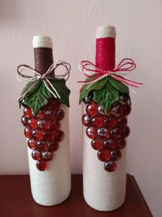 two wine bottles made to look like grapes