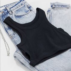 Never Worn Black Ribbed Cotton Tank Top, Casual Ribbed Crop Top For Streetwear, Trendy Black Ribbed Crop Top, Trendy Black Ribbed Tank Top, Black Ribbed Top For Streetwear, Trendy Ribbed Black Tank Top, Basic Black Spring Tank Top, Trendy Black Tank Top For Fall, Basic Black Tank Top For Spring