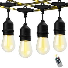 five light bulbs are hanging from the ceiling with remote controls on each end and an extension cord is connected to them