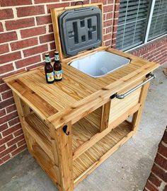 an outdoor cooler with two beer bottles in it