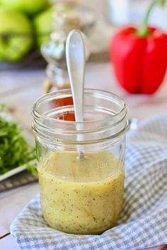 an easy and fresh poppy seed dressing recipe in a mason jar with a spoon inside