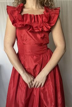 Details: acetate; maxi length; ruffle hemline; full skirt; corset style top (no boning, just darts); ruffle trim around neckline; zip up and hook and eye closure in the back.  Damage: small marks around neckline perhaps from where stitching used to be (covered by ruffle so hardly noticeable); ruffle around neckline needs to be re-stitched in a couple places; minor discoloration under armpits (not noticeable); few stains in the skirt throughout (not noticeable).  Shoulders: 15 in; Pit to Pit: 34 Fitted Sleeveless Gown With Ruffles, Fitted Maxi Dress With Ruffled Straps, Taffeta Ball Gown With Ruffles, Taffeta Prom Dress With Ruffles, Floor-length Ruffled Dresses For Costume Party, Satin Maxi Dress With Ruffles For Prom, Taffeta Prom Gown With Ruffles, Evening Gown With Fitted Ruffled Straps, Satin Ruffled Gown For Prom Season