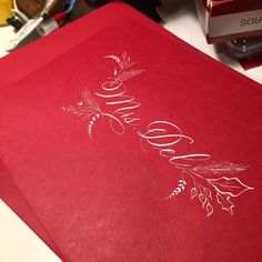 a red folder with the word love written on it and some other items around it