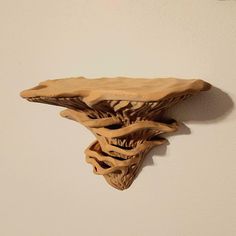 a wooden sculpture is hanging on the wall