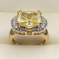 For Sale, A Stunning And Rare Yellow Tourmaline (3.49 Carats Main Stone) 14 Karat Yellow Gold Ring. Size: 5 Weight: 5.85 Grams Tourmaline: Radiant Cut, Rectangular, 8 Prong Held, Measuring 10 Mm Long X 8 Mm Wide For A Weight Of 3.49 Carats. Tourmaline: 2 Small Square Cut Stones, Bezel Held, Measuring 2 Mm Diameter (Total Of 0.12 Carats) Cubic Zirconia: Round, Prong And Bezel Set, Measuring 1.5 Mm Diameter, 24 Stones (0.36 Carats) Band Width Narrowest: 2 Mm Band Width Widest (Top Of Ring): 9.16 M Radiant Cut, Square Cut, Yellow Gold Ring, Pure Gold, Cocktail Ring, Bezel Setting, Womens Jewelry Rings, Yellow Gold Rings, Cocktail Rings